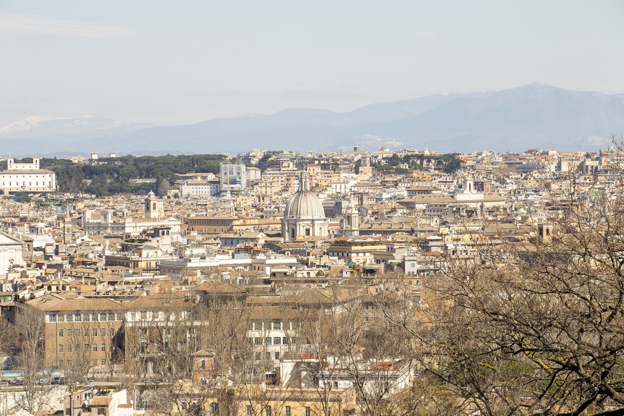 A panoramic view of the city of Rome featuring various buildings and a prominent dome.