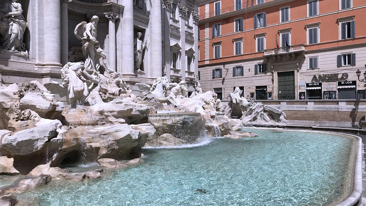 The image shows the Trevi Fountain with its ornate sculptures and clear water.